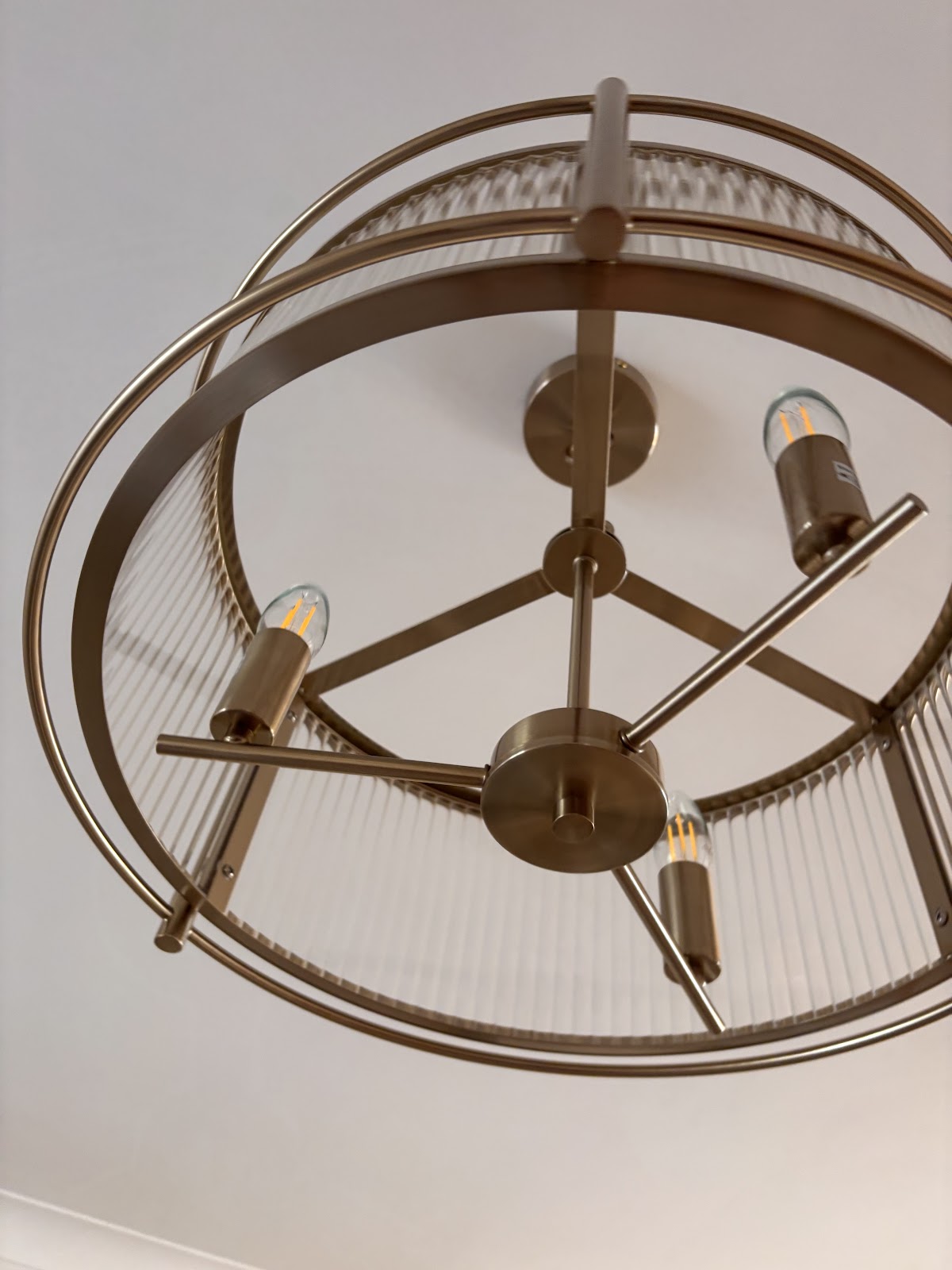 Close-up of a brass caged pendant with warm filament lamps — one of DGC's feature lighting installs.